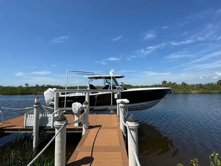  Yacht Photos Pics 2024 Blackfin 332 CC boat docked on a sunny day with clear blue skies.