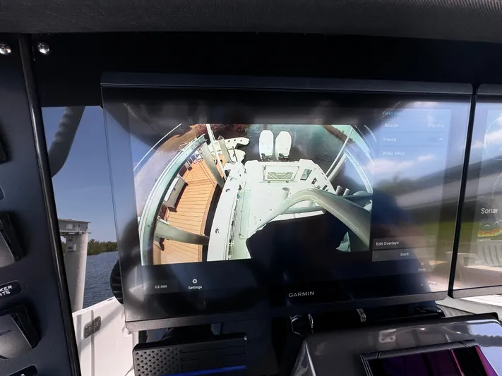  Yacht Photos Pics 2024 Blackfin 332 CC boat dashboard with Garmin display showing navigation and sonar.