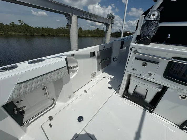  Yacht Photos Pics 2024 Blackfin 332 CC boat interior with storage compartments and scenic water view.
