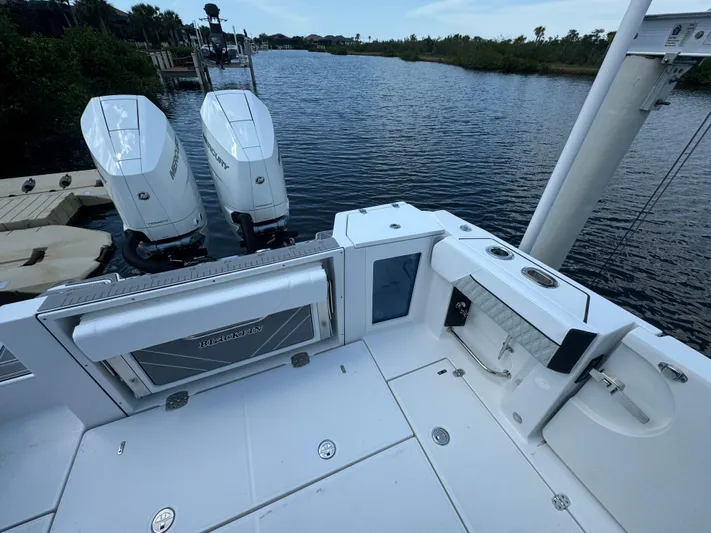  Yacht Photos Pics 2024 Blackfin 332 CC boat with dual engines docked by a scenic waterway.