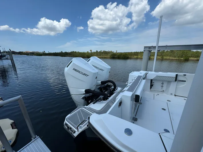  Yacht Photos Pics 2024 Blackfin 332 CC boat with dual Mercury engines docked on a sunny day.