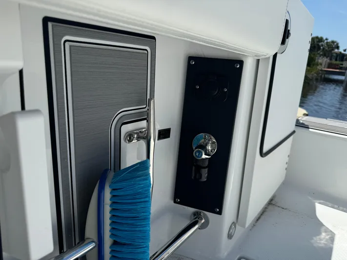  Yacht Photos Pics 2024 Blackfin 332 CC boat interior with cleaning brush and control panel.