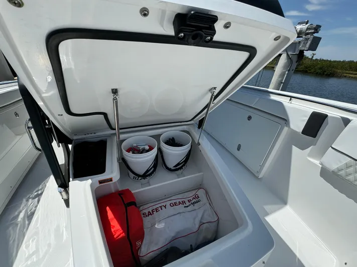  Yacht Photos Pics 2024 Blackfin 332 CC boat storage compartment with safety gear and equipment.