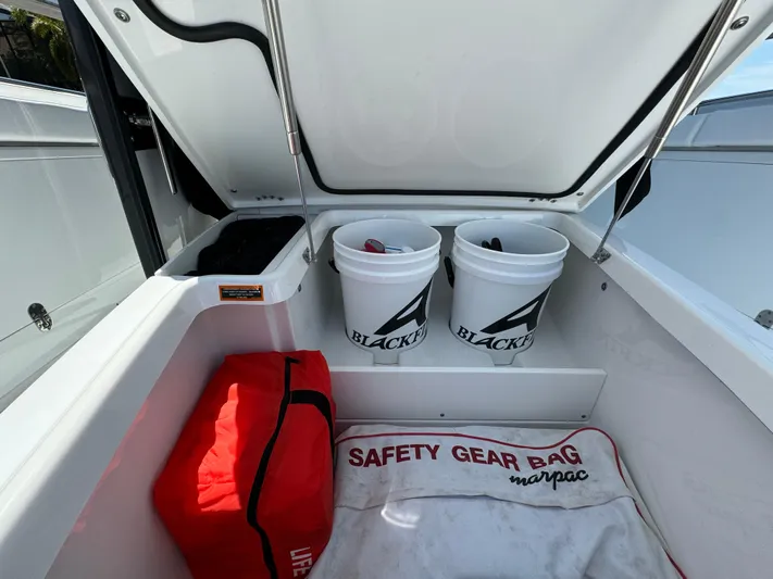  Yacht Photos Pics 2024 Blackfin 332 CC boat storage with safety gear bag and branded buckets.
