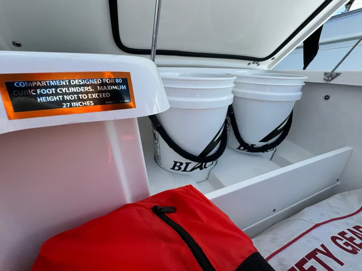  Yacht Photos Pics 2024 Blackfin 332 CC storage compartment with buckets and safety gear.