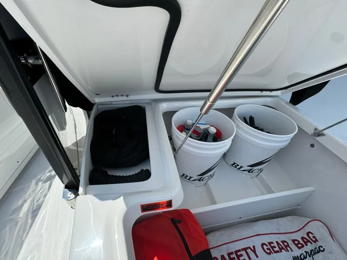  Yacht Photos Pics 2024 Blackfin 332 CC boat storage with safety gear and equipment buckets.