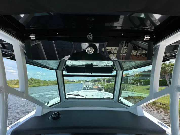  Yacht Photos Pics 2024 Blackfin 332 CC boat interior with windshield view of waterway.