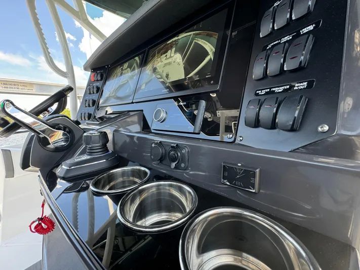 Yacht Photos Pics 2024 Blackfin 332 CC boat dashboard with controls and cup holders.
