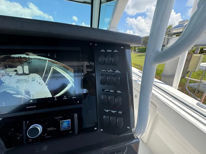  Yacht Photos Pics 2024 Blackfin 332 CC boat dashboard with Garmin display and control panel.