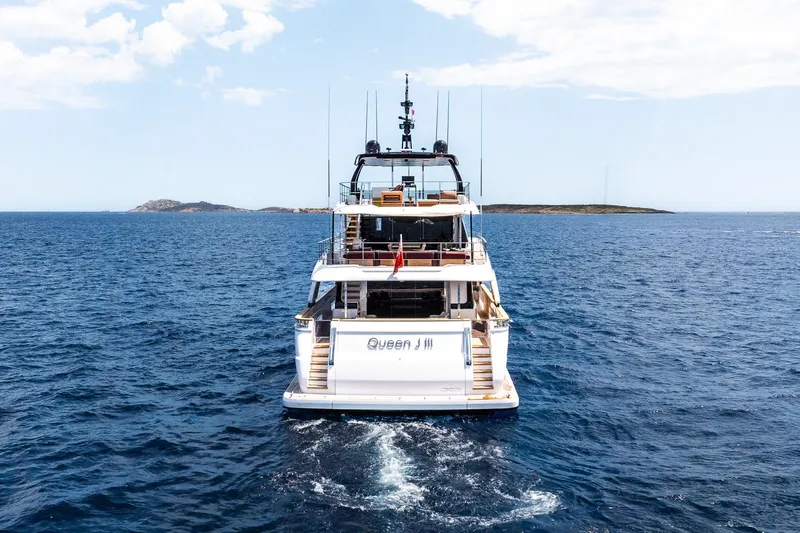Queen J III Yacht Photos Pics 2024 Custom Line Navetta 33 yacht cruising on open sea, rear view.