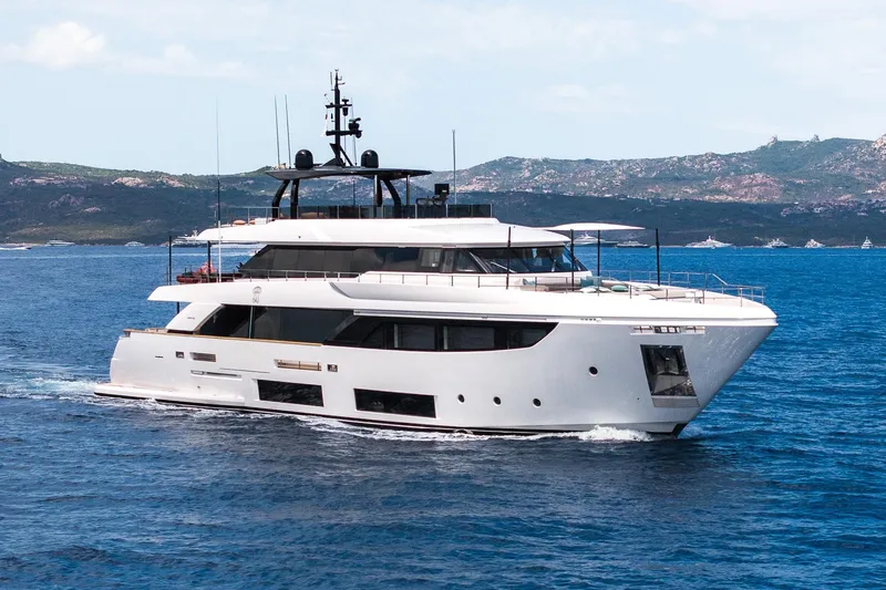 Queen J III Yacht Photos Pics Luxurious 2024 Custom Line Navetta 33 yacht cruising on serene blue waters.