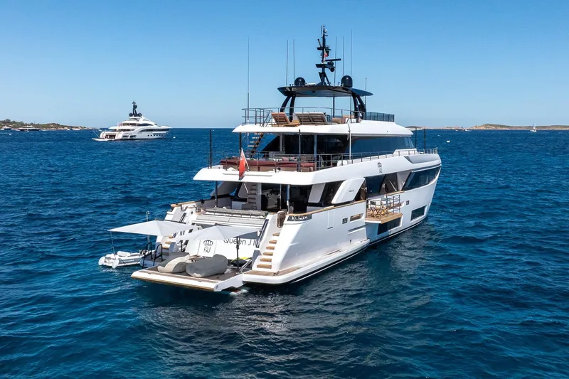 Queen J III Yacht Photos Pics 2024 Custom Line Navetta 33 yacht on open sea, showcasing luxury design and spacious decks.