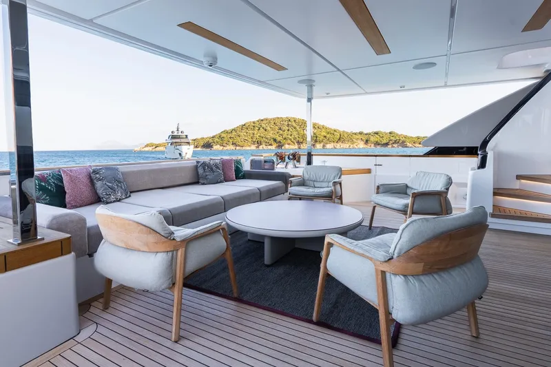 Queen J III Yacht Photos Pics Luxurious 2024 Custom Line Navetta 33 yacht deck with elegant seating and ocean view.