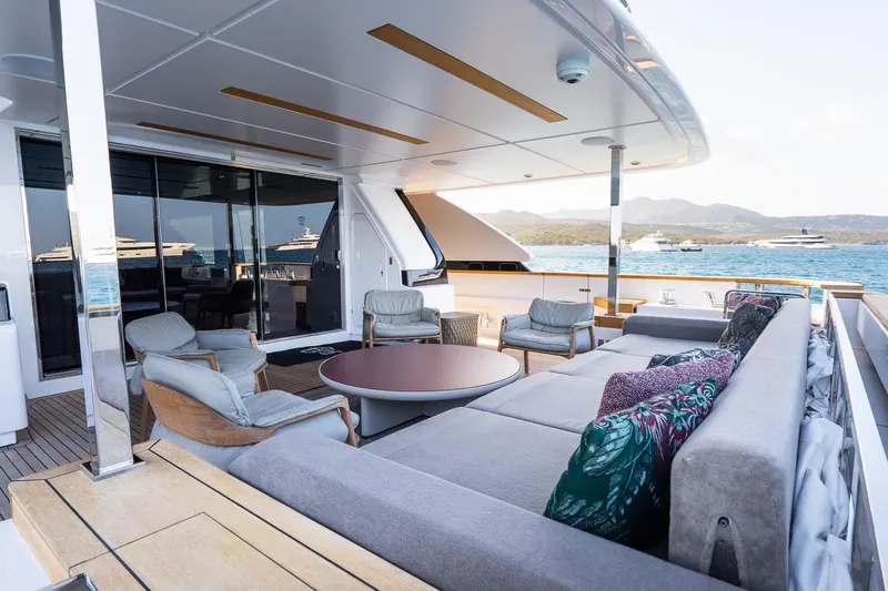 Queen J III Yacht Photos Pics Luxurious 2024 Custom Line Navetta 33 yacht deck with elegant seating and ocean view.