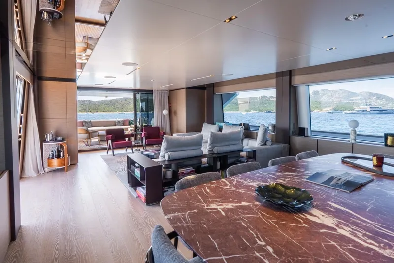 Queen J III Yacht Photos Pics Luxurious interior of 2024 Custom Line Navetta 33 yacht with elegant furnishings and scenic ocean views.