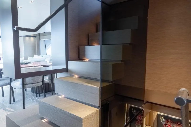 Queen J III Yacht Photos Pics Modern interior staircase on 2024 Custom Line Navetta 33 yacht, featuring sleek design and ambient lighting.