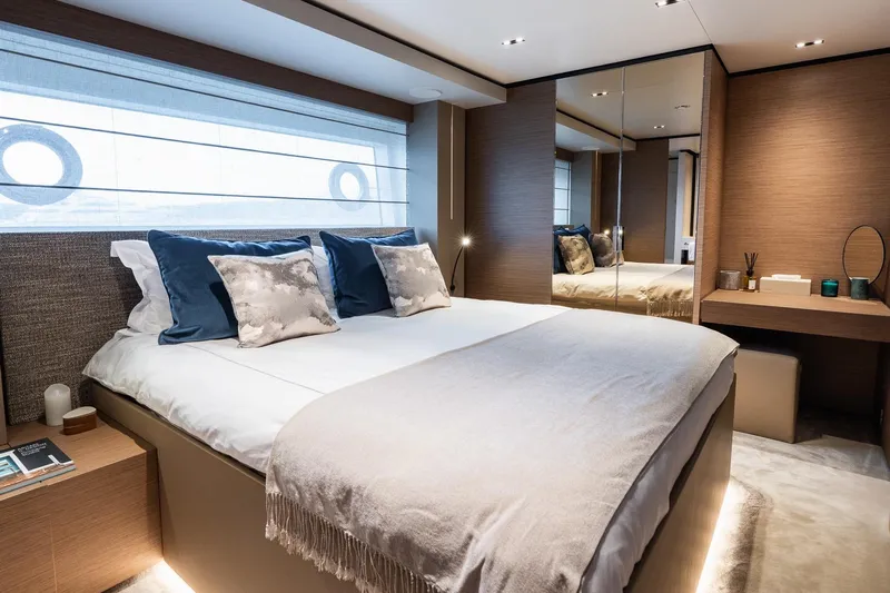 Queen J III Yacht Photos Pics Luxurious bedroom interior on 2024 Custom Line Navetta 33 yacht, featuring elegant decor and modern amenities.