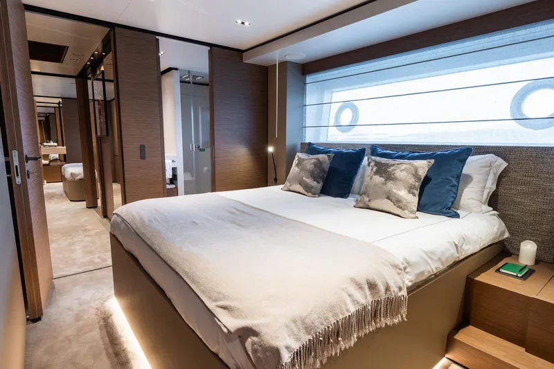 Queen J III Yacht Photos Pics Luxurious bedroom interior of 2024 Custom Line Navetta 33 yacht, featuring elegant decor and plush bedding.