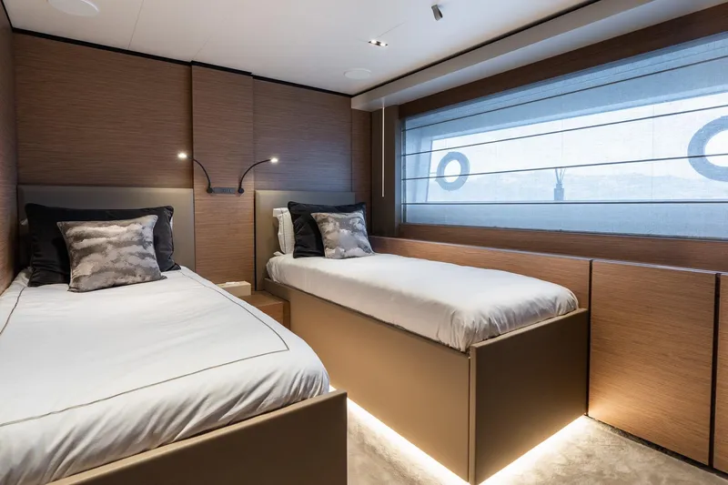 Queen J III Yacht Photos Pics Luxurious twin bedroom on 2024 Custom Line Navetta 33 yacht, featuring modern design and ambient lighting.