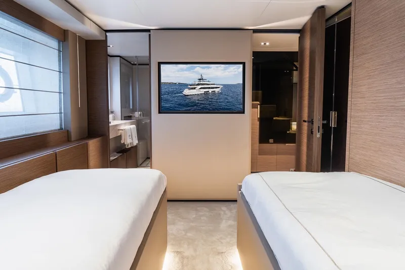 Queen J III Yacht Photos Pics Luxurious interior of 2024 Custom Line Navetta 33 yacht with twin beds and TV.