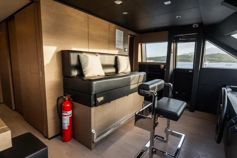 Queen J III Yacht Photos Pics Luxurious interior of 2024 Custom Line Navetta 33 yacht with seating and ocean view.