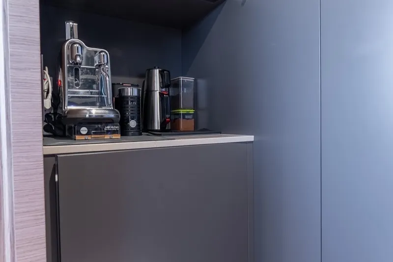 Queen J III Yacht Photos Pics Modern kitchen corner with espresso machine and appliances on Custom Line Navetta 33 yacht, 2024.