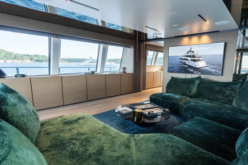 Queen J III Yacht Photos Pics Luxurious interior of 2024 Custom Line Navetta 33 yacht with plush seating and ocean view.