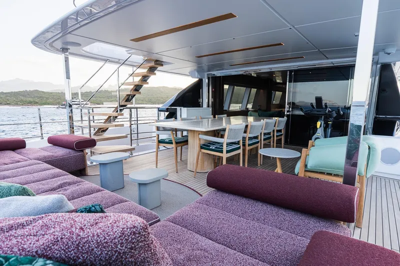 Queen J III Yacht Photos Pics Luxurious 2024 Custom Line Navetta 33 yacht deck with elegant seating and dining area.