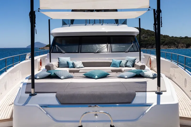 Queen J III Yacht Photos Pics Luxurious 2024 Custom Line Navetta 33 yacht deck with cushions, ocean view.