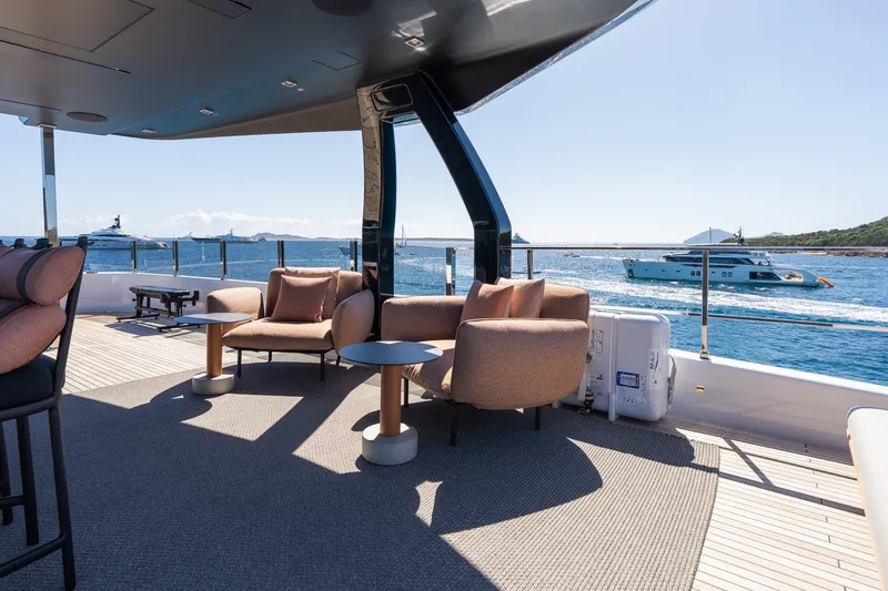 Queen J III Yacht Photos Pics Luxurious deck of 2024 Custom Line Navetta 33 yacht with ocean view and comfortable seating.