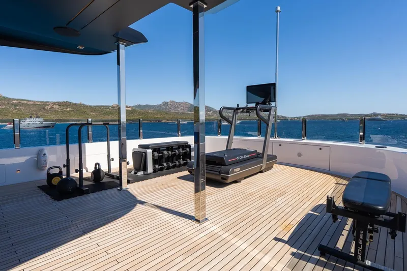 Queen J III Yacht Photos Pics Outdoor gym on 2024 Custom Line Navetta 33 yacht with treadmill and weights, ocean view.