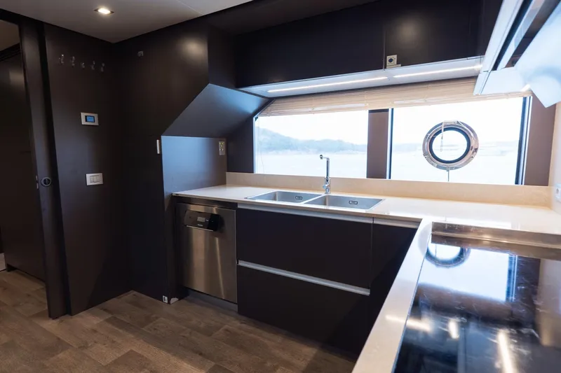 Queen J III Yacht Photos Pics Modern kitchen interior on 2024 Custom Line Navetta 33 yacht, featuring sleek design and ocean view.