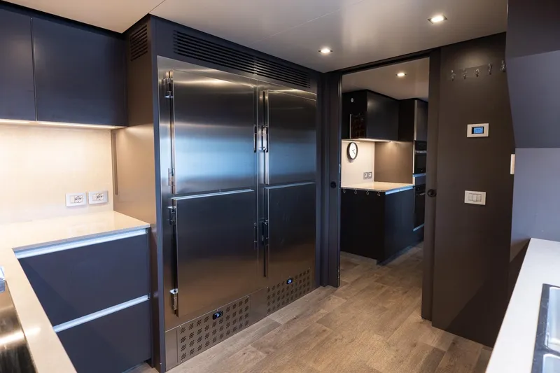 Queen J III Yacht Photos Pics Luxurious 2024 Custom Line Navetta 33 yacht kitchen with sleek stainless steel appliances.