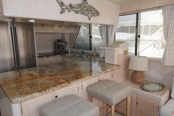 Ms Mickey Yacht Photos Pics Luxurious 1998 Ocean Alexander Yachtfish Command Bridge interior with elegant kitchen and seating area.