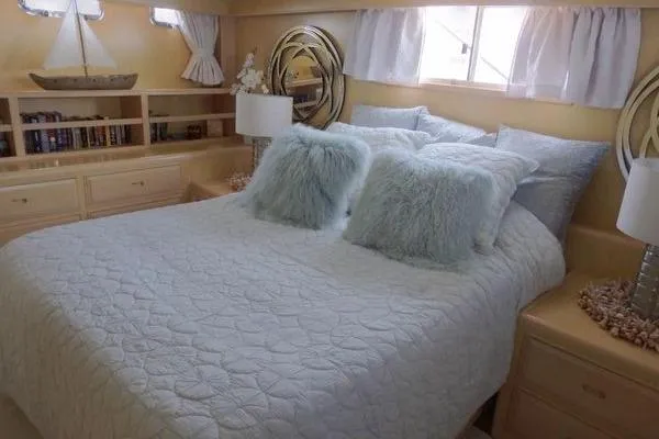 Ms Mickey Yacht Photos Pics Luxurious bedroom interior of 1998 Ocean Alexander Yachtfish Command Bridge with plush bedding.
