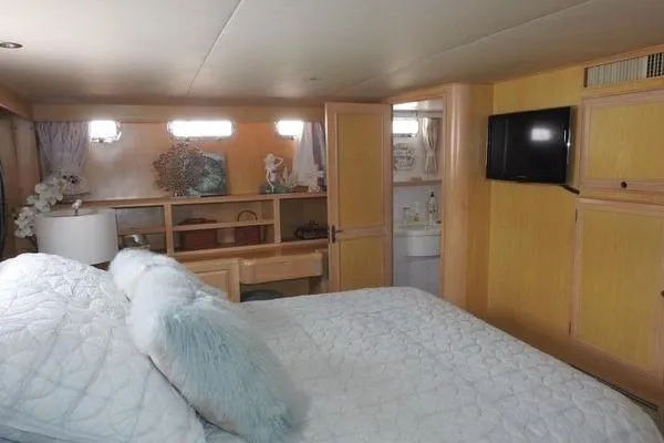 Ms Mickey Yacht Photos Pics Luxurious bedroom in 1998 Ocean Alexander Yachtfish Command Bridge with cozy decor and modern amenities.