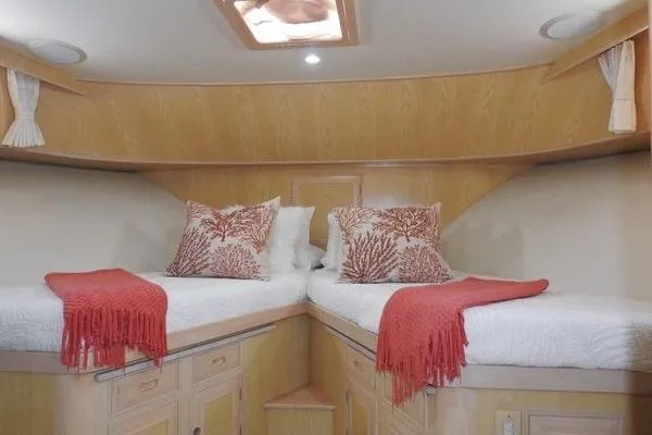 Ms Mickey Yacht Photos Pics Luxurious 1998 Ocean Alexander Yachtfish Command Bridge cabin with twin beds and coral-themed decor.