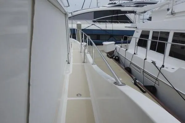 Ms Mickey Yacht Photos Pics 1998 Ocean Alexander Yachtfish Command Bridge, side deck view with railing and neighboring boats.