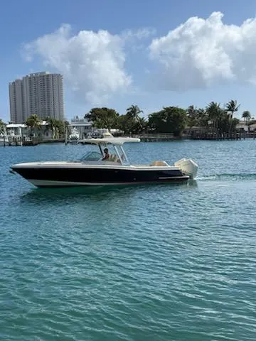  Yacht Photos Pics 2020 Chris-Craft Calypso 30 boat cruising on a sunny day in a coastal area.