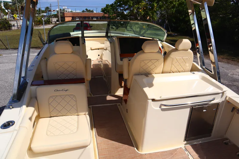  Yacht Photos Pics 2020 Chris-Craft Calypso 30 boat interior with beige seating and helm station.