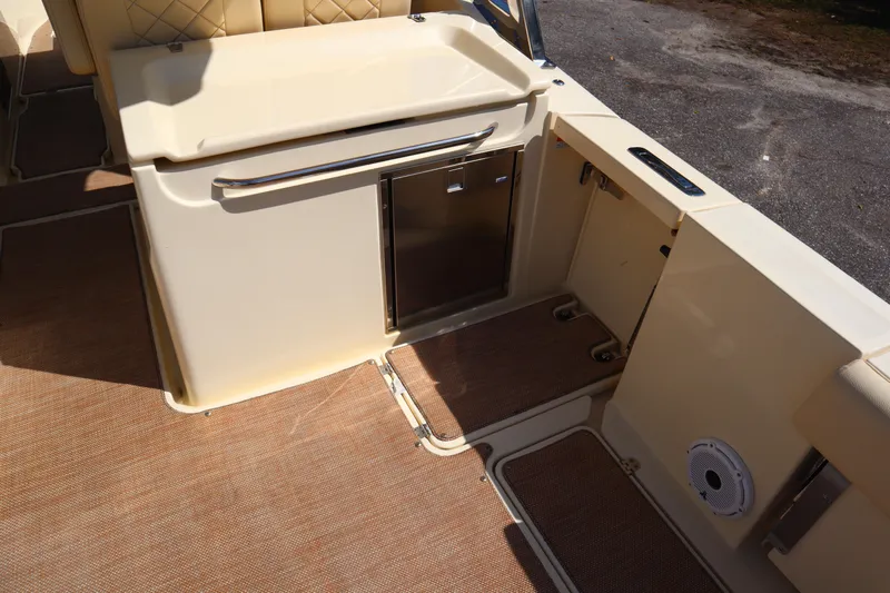  Yacht Photos Pics 2020 Chris-Craft Calypso 30 boat interior with storage compartments and cushioned seating.