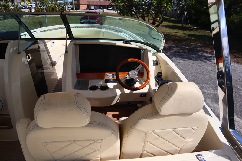  Yacht Photos Pics 2020 Chris-Craft Calypso 30 helm with beige seats and wooden steering wheel.