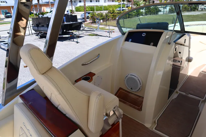  Yacht Photos Pics 2020 Chris-Craft Calypso 30 interior with beige seating and modern dashboard.