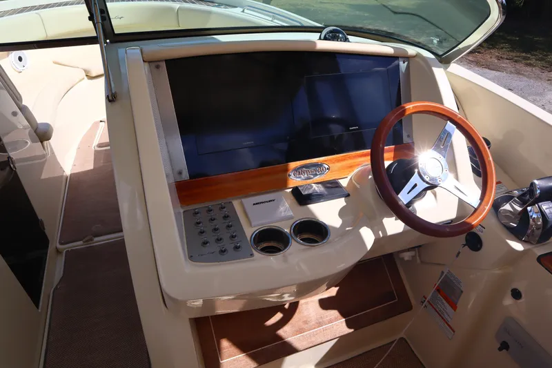  Yacht Photos Pics 2020 Chris-Craft Calypso 30 dashboard with steering wheel and control panel.