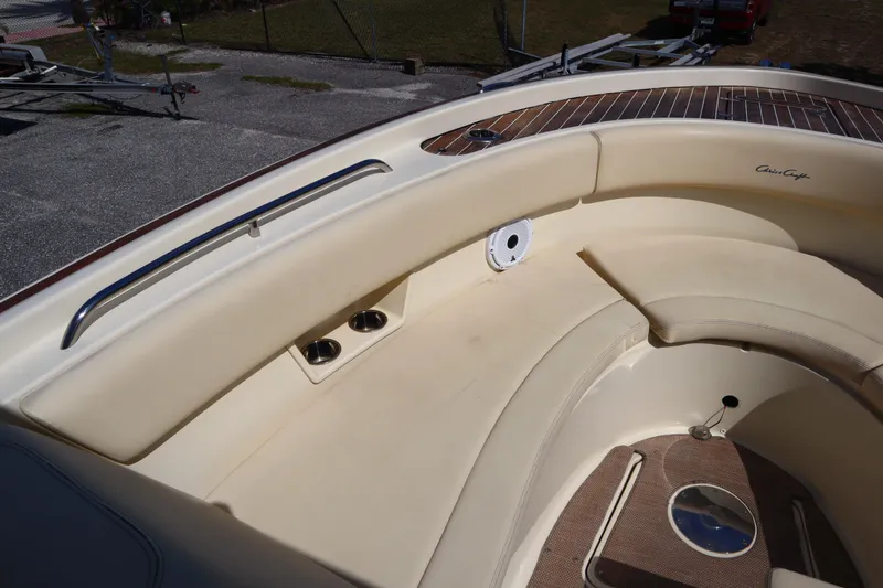  Yacht Photos Pics 2020 Chris-Craft Calypso 30 boat interior with beige seating and wood accents.