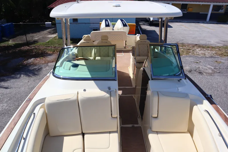 Yacht Photos Pics 2020 Chris-Craft Calypso 30 boat interior with beige seating and open deck layout.