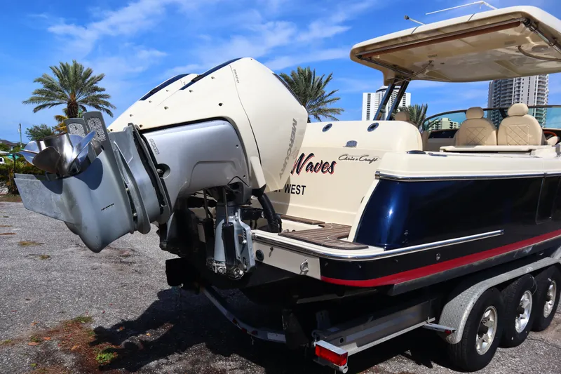  Yacht Photos Pics 2020 Chris-Craft Calypso 30 boat on trailer, featuring powerful outboard motor.