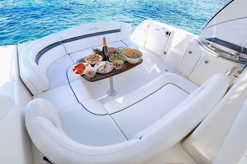  Yacht Photos Pics Luxurious 2006 Sea Ray Sundancer with elegant seating and a table set for dining.