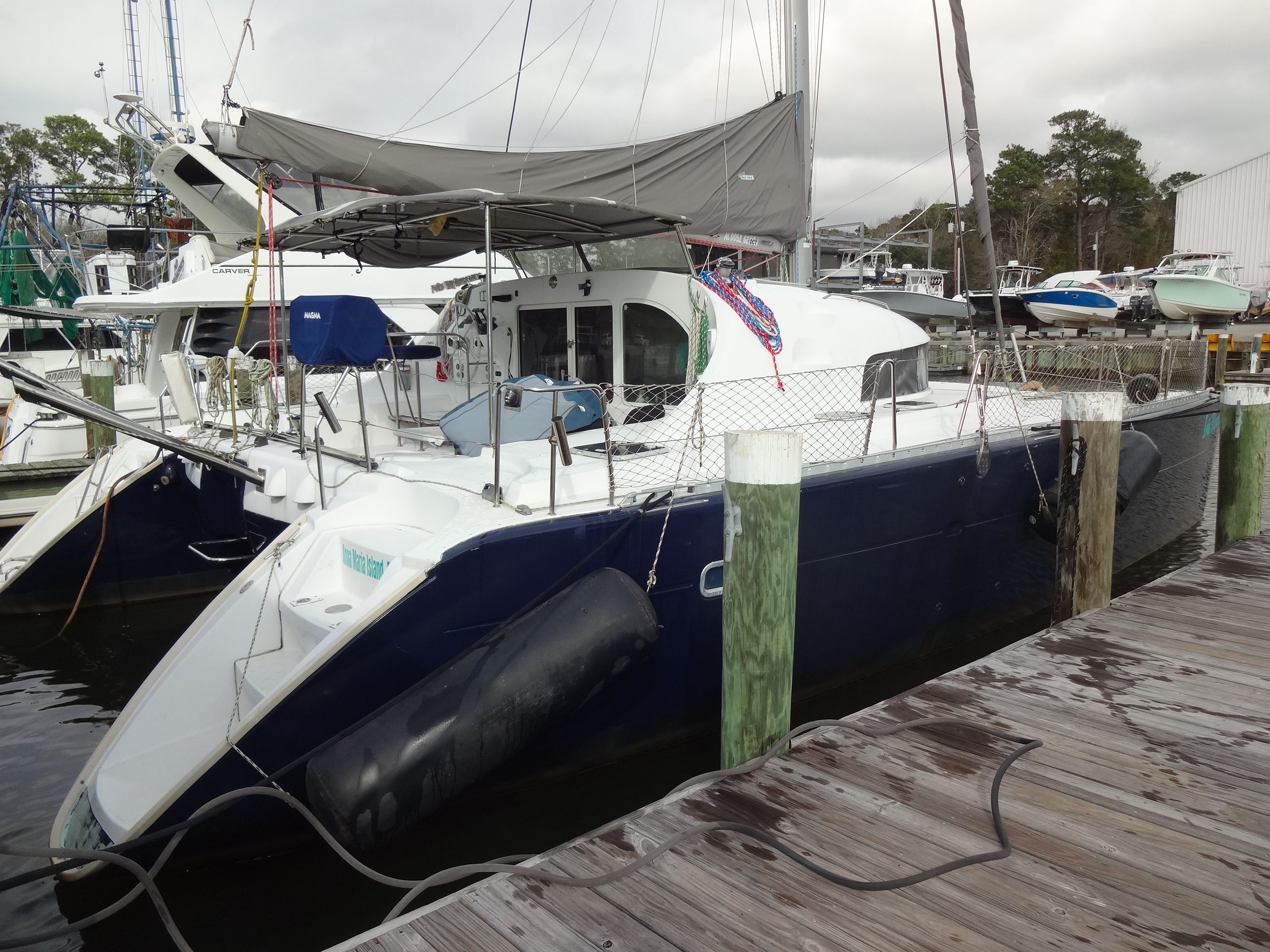 2003 Lagoon 410 catamaran docked at marina.
