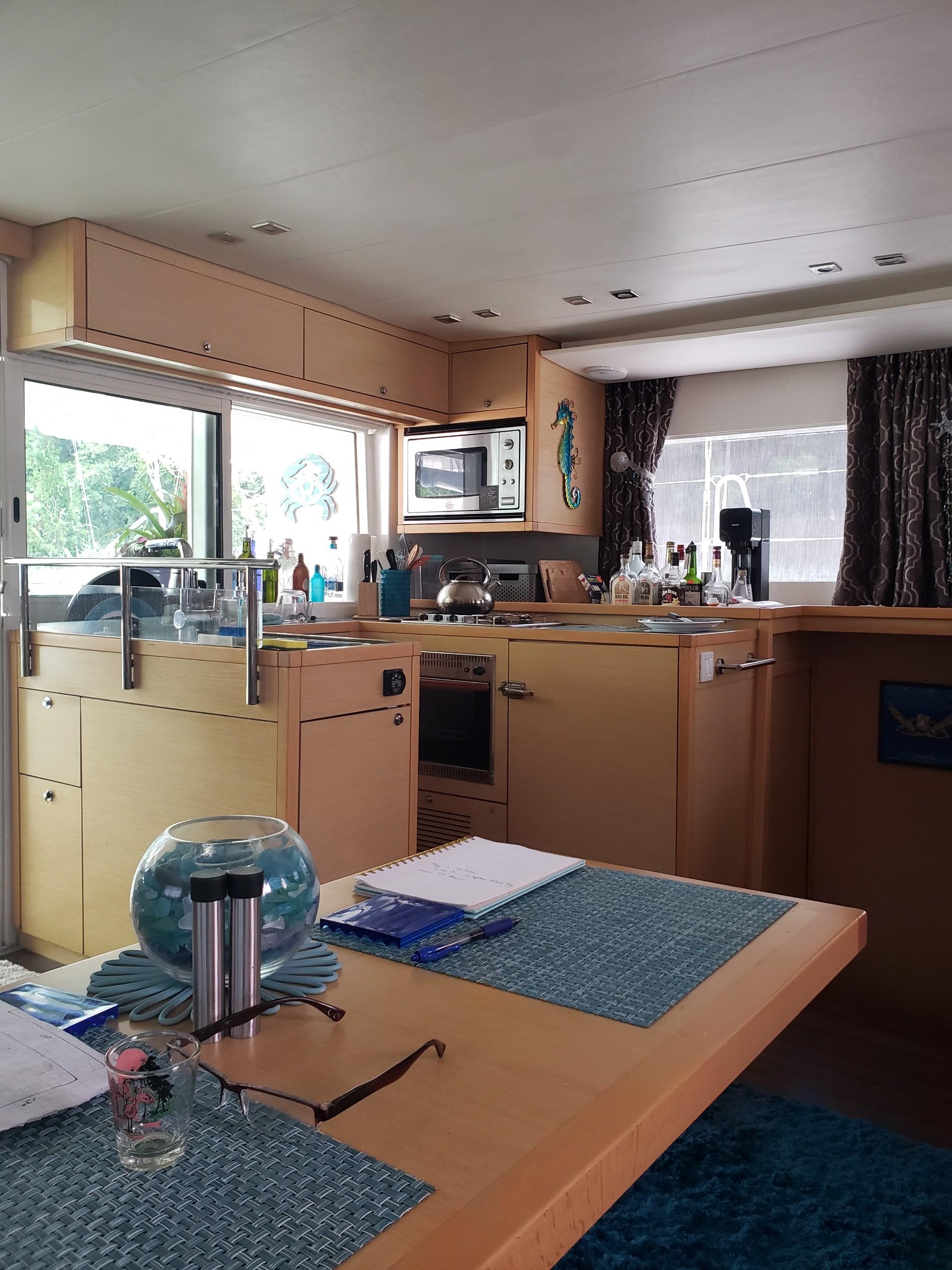 Interior of a 2011 Lagoon 450 catamaran with modern kitchen and dining area.